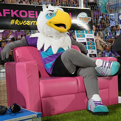 NWU Eagi sitting on a couch at Varsity Cup