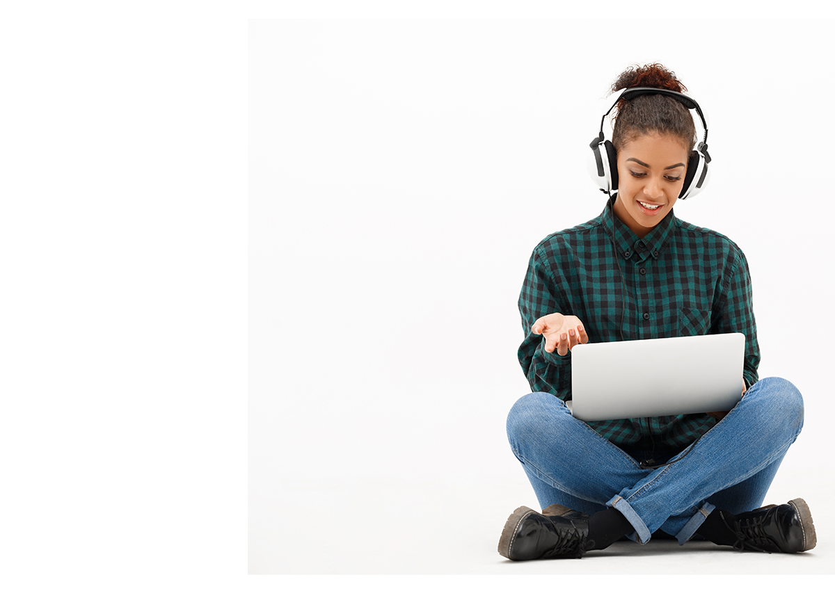 Student using a laptop and headphones